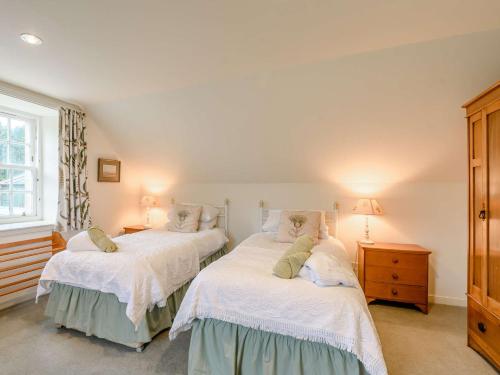 two beds in a room with white walls at 4 Bed in AYR 90038 in Ayr