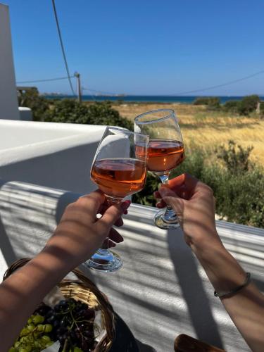 two people holding up glasses of wine at Studio Tolakis in Plaka