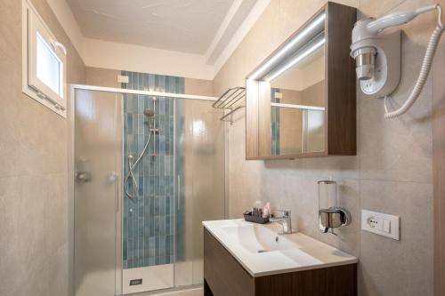 a bathroom with a sink and a shower at Hotel Capinera in Caorle