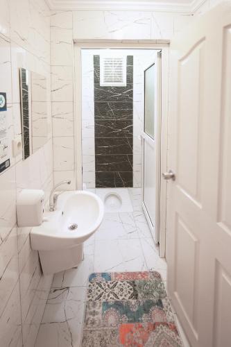 a white bathroom with a sink and a toilet at Cayeli Kent Apart in Cayeli