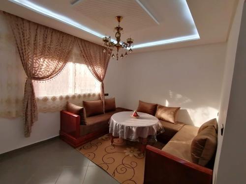 a living room with a couch and a table at Banana Beach Flat in Agadir