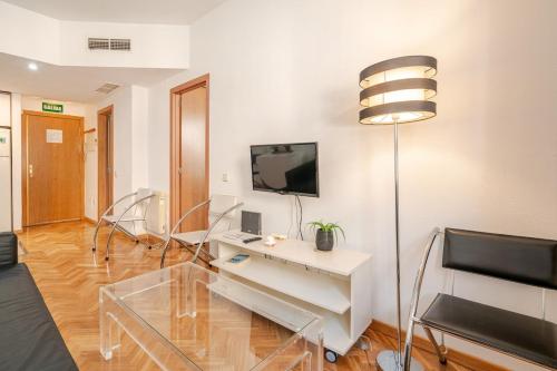 a living room with a table and a tv at Apartamento turístico mad-aeropuerto ifema in Madrid