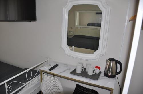 a room with a table with a mirror and a bed at Asmundo Palace Suites & Spa in Catania