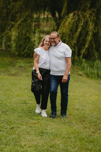 a man and a woman standing in a field at Lacurile IRION in Hoghilag