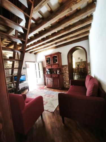 a living room with a red couch and a mirror at Casa vacanze il ciclope in Erice
