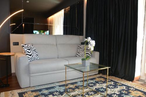 a living room with a couch and a glass table at Alba Suites in Vlorë