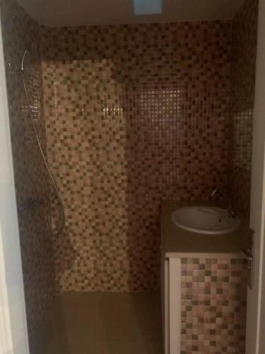 a bathroom with a tub and a sink in a room at Haut standing studio meublé in Nabeul