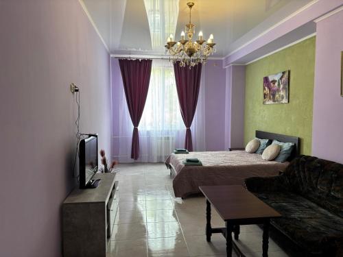 a living room with a bed and a couch at SunLake Hotel Osokorki in Kyiv