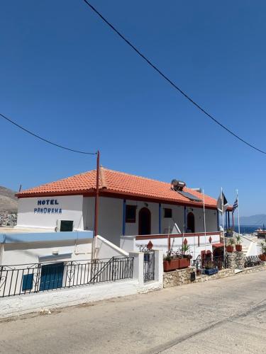 a white building on the side of a street at Panorama Hotel in Kalymnos
