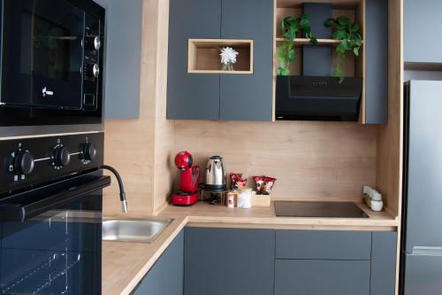 a small kitchen with a sink and a stove at Luxury condos on 18th, 5th and 3rd floor, with pool, fitness, parking included in Skopje