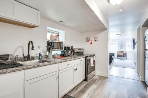 a kitchen with white cabinets and a sink at Dog-Friendly Apt with Yard 10 Mi to Downtown in Chicago