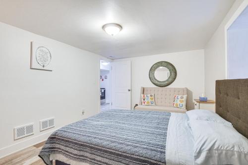 a white bedroom with a bed and a mirror at Dog-Friendly Apt with Yard 10 Mi to Downtown in Chicago