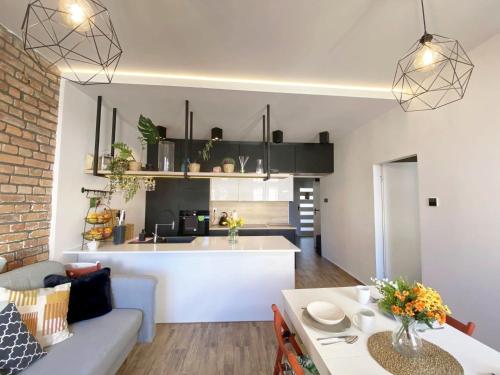 a living room and kitchen with a couch and a table at 67-Ratusz - DeerRest Apart in Jelenia Góra