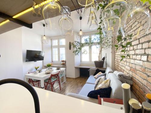 a living room and dining room with a brick wall at 67-Ratusz - DeerRest Apart in Jelenia Góra