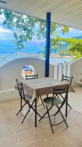 a table and chairs with a view of a beach at Anyavee Chom By The Sea in Ao Nam Mao