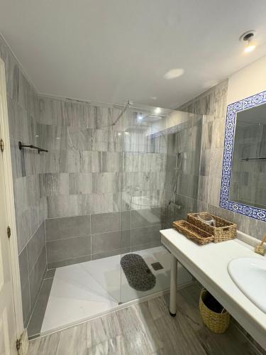 a bathroom with a shower and a sink at Casa de Dolores in Estepona