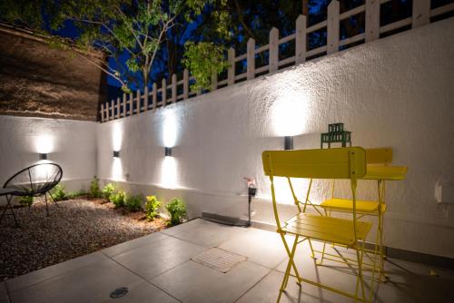 a yellow chair sitting on a patio at night at Jardin maison in Itea