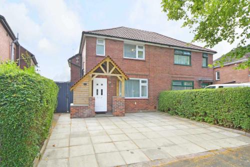 a brick house with a white door at Polaris House - sleeps 6, driveway, garden in Crewe