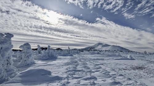 a snow covered road with a mountain in the background at Balcons de Sorgeat - Chambres d'hôtes - Ecolodge en montagne in Sorgeat