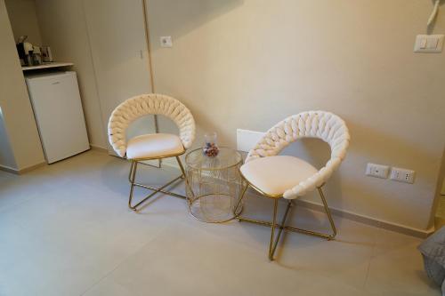 two chairs and a glass table in a room at Sott'o Cambanil in Gioia del Colle