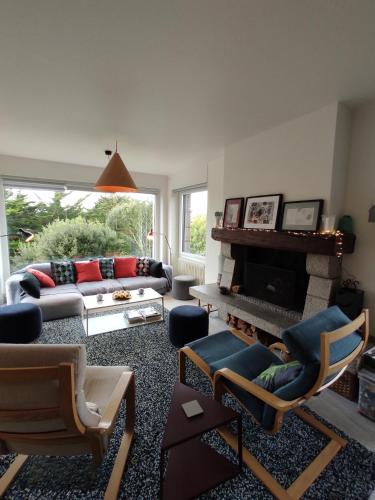 a living room with a couch and a fireplace at 50m plage- Fréhel - Bien rare - Cadre exceptionnel in Frehel