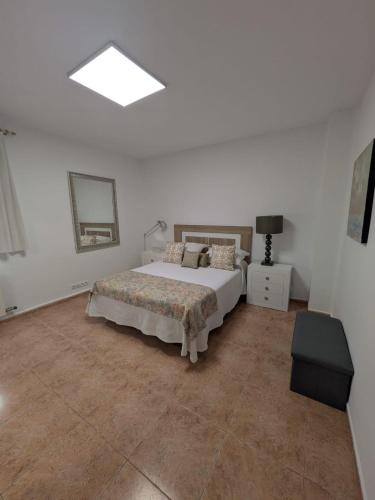 a bedroom with a bed and a mirror on the wall at El HORTAL in Alberite