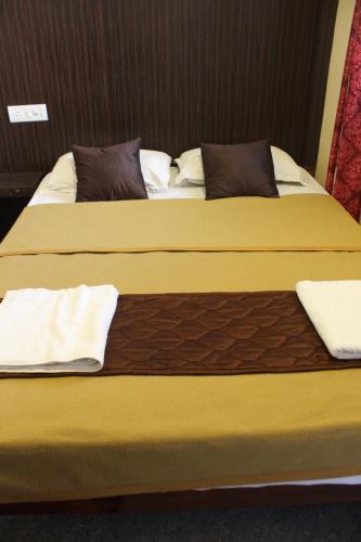 two beds in a hotel room with two bedsskirts at Shaan stay inn in Kanchipuram