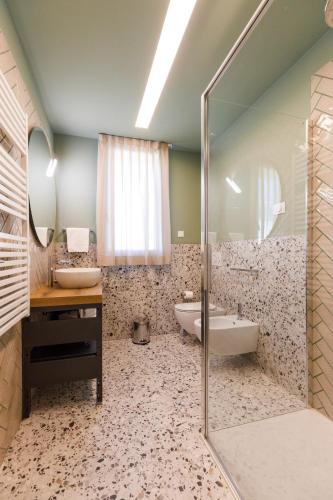 a bathroom with a shower and a tub and a sink at Casa Colombo Apartments in Bardolino