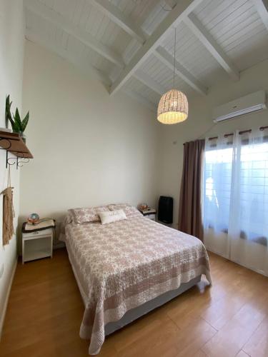 a bedroom with a bed and a large window at Buen Descanso I in San Pedro