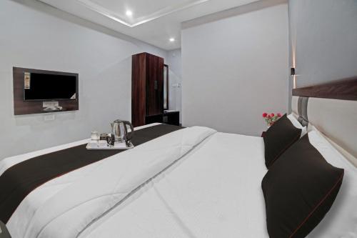 a bedroom with a large bed and a television at Palette - The Mark Club & Resorts in Durg