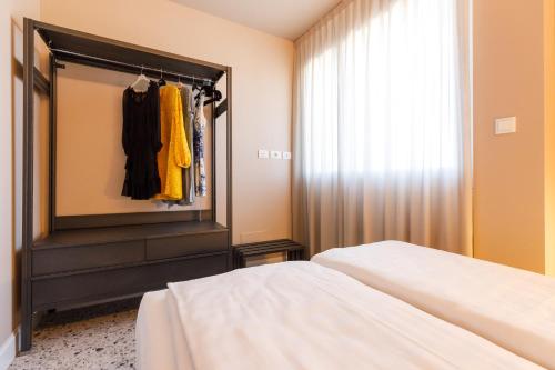 a bedroom with a bed and a dresser and a mirror at Casa Colombo Apartments in Bardolino