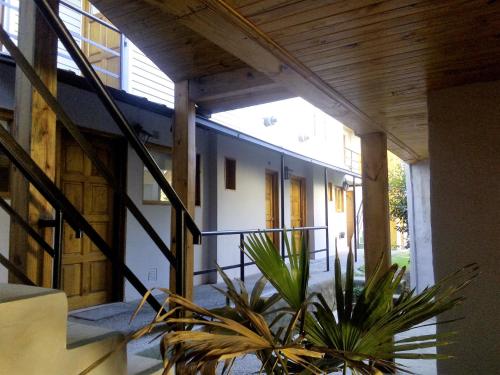 a house with a potted plant on a balcony at BOG Angostura Apartments in Villa La Angostura