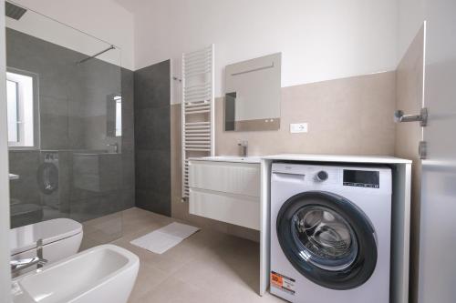 a bathroom with a washer and a washing machine at Luxury Penthouses Romeo e Giulietta by GG Apartments in Gallipoli