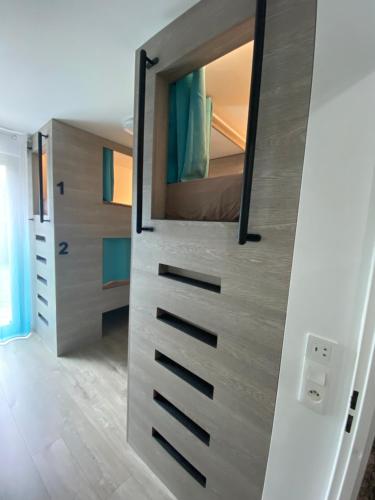 a bedroom with a bunk bed with a mirror at Lit 2 en 1ère Classe-Orly-T7-RER C&D in Athis-Mons