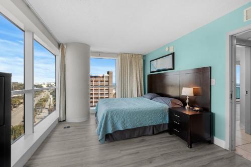 a bedroom with a bed and a large window at 2 King Beds & Ocean Views! Oceans One 601 in Myrtle Beach