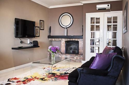 a living room with a glass table and a fireplace at Sunset Beach Apartment in Vila Praia de Âncora