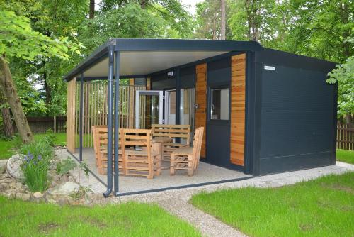 a black shed with a table and chairs in it at Emina Hiška in Braslovče
