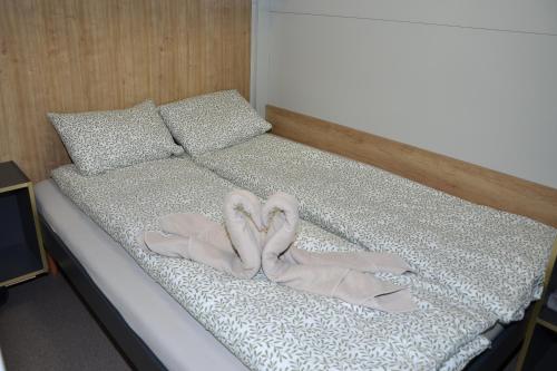 a bed with two pairs of shoes on it at Emina Hiška in Braslovče