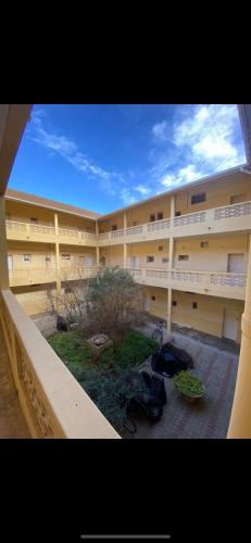 a large apartment building with a view of a courtyard at Studio front de mer Valras-Plage 2-4 personnes in Valras-Plage