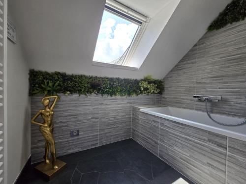 a bathroom with a bath tub and a window at L instant Love, passion pure in Verneuil d’Avre et d’Iton