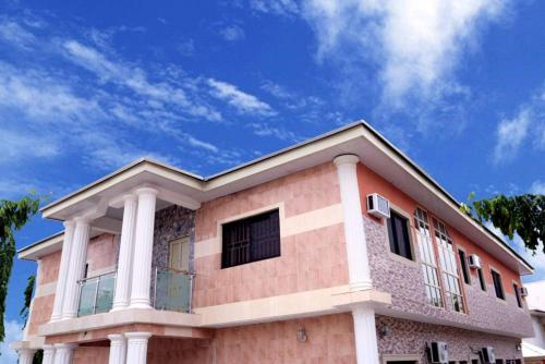 a building with a blue sky in the background at Dilida Hotel in Abuja