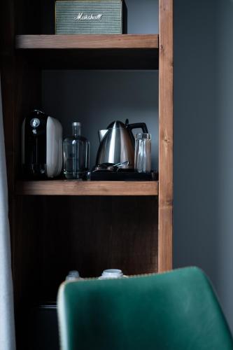 a shelf with a tea kettle and other items on it at Octant Furnas in Furnas