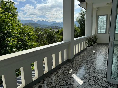 a balcony with a view of the mountains at Garden House Rice Field and Mountain View in Luang Prabang