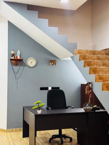 an office with a desk and a staircase at Negombo Signature Villa in Negombo