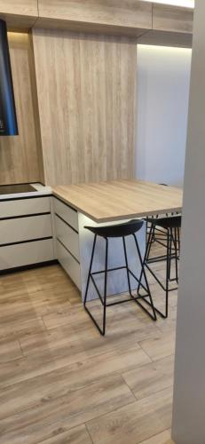 a kitchen with a table and two stools at concept 9 in Târgu-Mureş