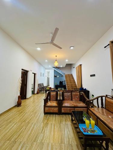 a living room with a couch and a table at Negombo Signature Villa in Negombo