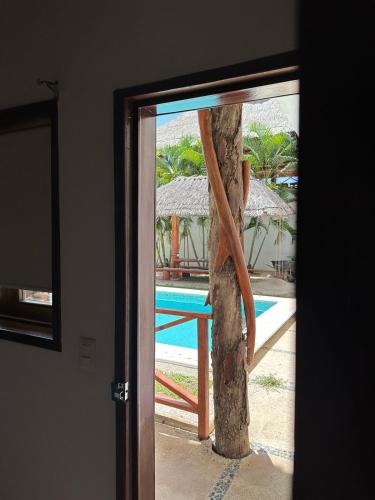 a view of a pool through a sliding glass door at Club Cenotes Tulum in Balcheil