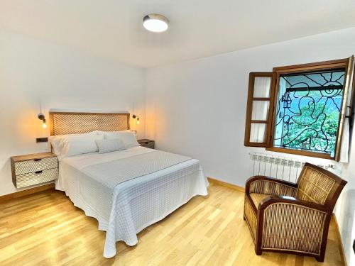 a bedroom with a bed and a stained glass window at Fuentes del Narcea apartamentos rurales in Cangas del Narcea