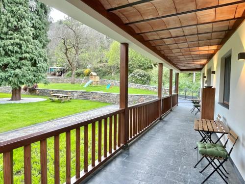 a porch with a view of a park at Fuentes del Narcea apartamentos rurales in Cangas del Narcea