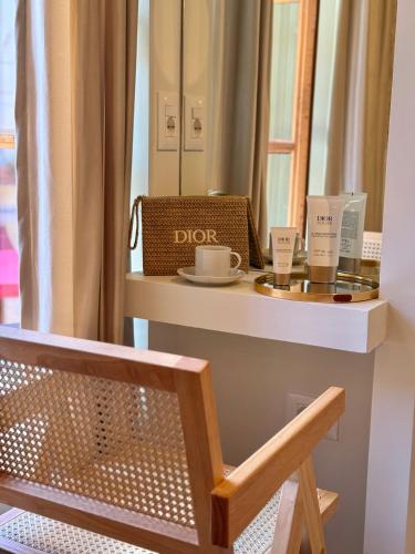 a dressing table with two cups and a mirror at Old Town Suites Muradie in Vlorë